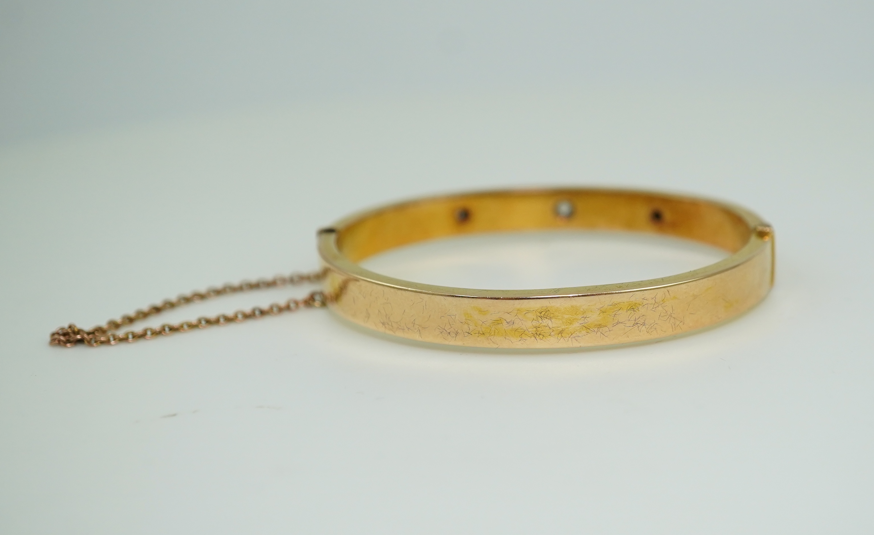 An Edwardian 15ct gold and diamond bangle, circa 1904